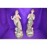 A pair of shepherd figures by Royal Dux having stamp to base one figure having slight damage