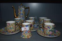 A part coffee service having gilt and paisley transfer print design