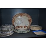 An assortment of vintage ceramics including Meakin plates, platters and bowls.