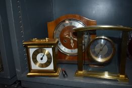 An art deco mantle clock and two similar brass bodied mantle clocks