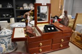 A jewellery box and a variety of cufflinks and brooches.