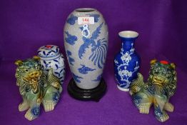 A collection of oriental ceramics and a pair of foo dogs.