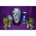 A collection of oriental ceramics and a pair of foo dogs.