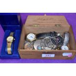 A vintage wooden cigar box containing a selection of necklaces and wrist watches including a cased