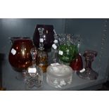 A selection of clear cut and colour art glass including large brandy or wine glass and bells