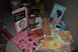 An assortment of vintage hairdressing items including three mid century books, large novelty