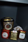 Three vintage travel clocks and a carriage/mantel clock also included is a Lladro ceramic clock.