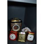 Three vintage travel clocks and a carriage/mantel clock also included is a Lladro ceramic clock.