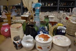 An assortment of vintage and retro ceramics including moto ware and blue glass vase.