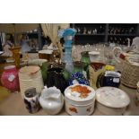 An assortment of vintage and retro ceramics including moto ware and blue glass vase.