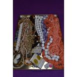 A selection of costume jewellery inclusing strings of beads, earrings etc