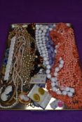 A selection of costume jewellery inclusing strings of beads, earrings etc