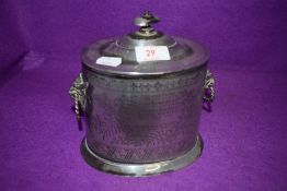 A silver plated biscuit barrel having mythical beast styled handles and retailed by Walker Hall