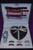 A cased Rainbow collection wrist watch set by Nina Myers having a variety of straps and besels