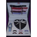 A cased Rainbow collection wrist watch set by Nina Myers having a variety of straps and besels