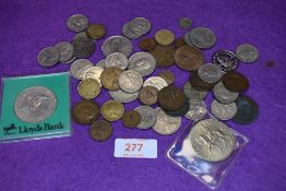 A small red jewellery case containing a small selection of British coins