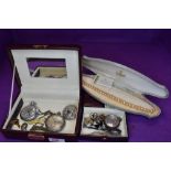 A travel jewellery box containing a small selection of costume jewellery including small silver