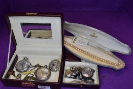 A travel jewellery box containing a small selection of costume jewellery including small silver