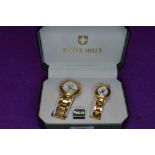A cased Swiss Hills His & Hers watch set