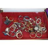 A small travel jewellery case containing a selection of costume jewellery rings of various forms