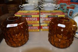 Two mid century amber coloured glass lamp shades and four boxes of Shepherd Minicastors.