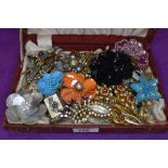 A box containing a selection of costume jewellery brooches including beaded, diamante etc