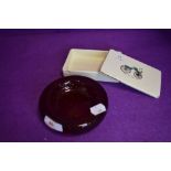 A ruby red control bubble glass dish and ceramic lidded container with transport imagery