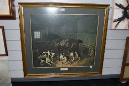 A large framed and glazed print of horse and dogs in stable