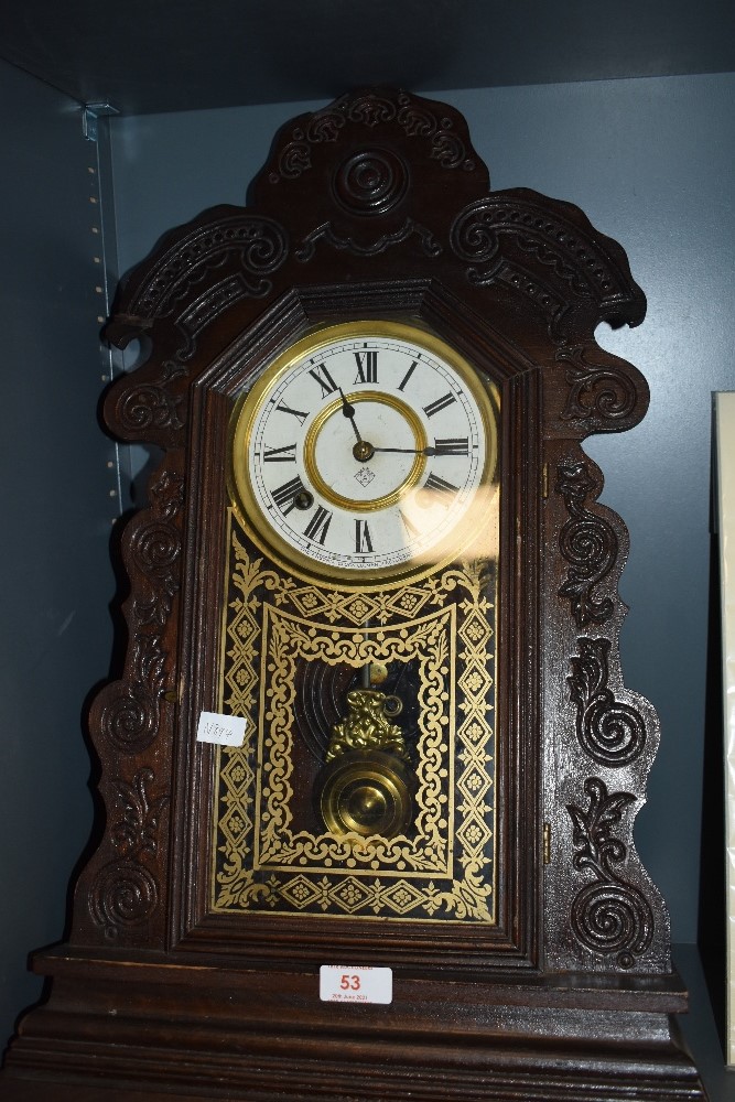 A Victorian wall mounted clock made by the Ansonia clock company in a Gothic design