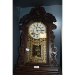 A Victorian wall mounted clock made by the Ansonia clock company in a Gothic design