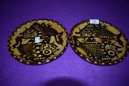 A pair of Hampton pottery earthenware plates having fish in brown and green hues depicted to Ochre