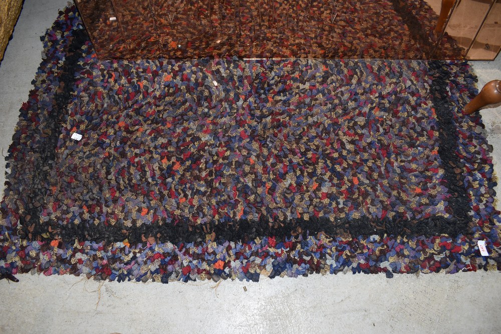 A traditional peg or rag rug with boarder
