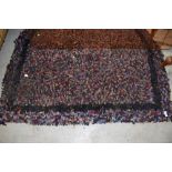 A traditional peg or rag rug with boarder