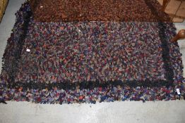 A traditional peg or rag rug with boarder