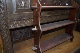 An early 20th Century flame mahogany bookcase/display cabinet, glazed centre section flaked by