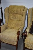 A pair of modern stained frame wing back easy chairs