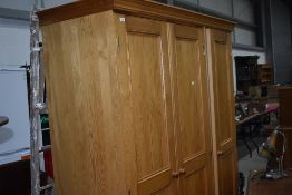 A modern pine triple wardrobe