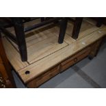 A rustic coffee table with frieze drawer