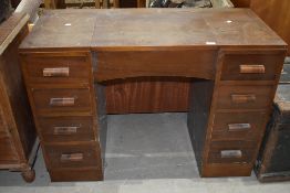 An early 20th Century stained frame dressing table having internal mirror on underside of central