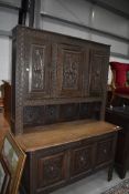 A late 19th century converted oak Kist base having similar dresser back with carved panel doors