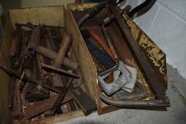 A selection of various hand tools including hide scrapers and set square