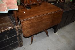 An antique mahogany fold out tea or breakfast table having one under drawer and one false