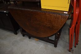 A traditional oak gate leg kitchen table having twist legs