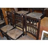 A set of five traditional spindle back rush seated dining chairs