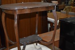 An early 20th Century mahogany occasional table having shaped top and undertier