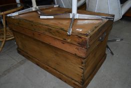 An antique pine chest having dovetail carcass with flat plank top