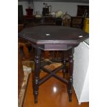 An antique wine table having mahogany frame with octagonal top on turned legs`