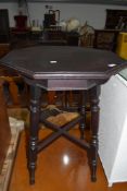 An antique wine table having mahogany frame with octagonal top on turned legs`