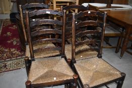 A set of four traditional rush seated ladderback chairs