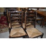 A set of four traditional rush seated ladderback chairs